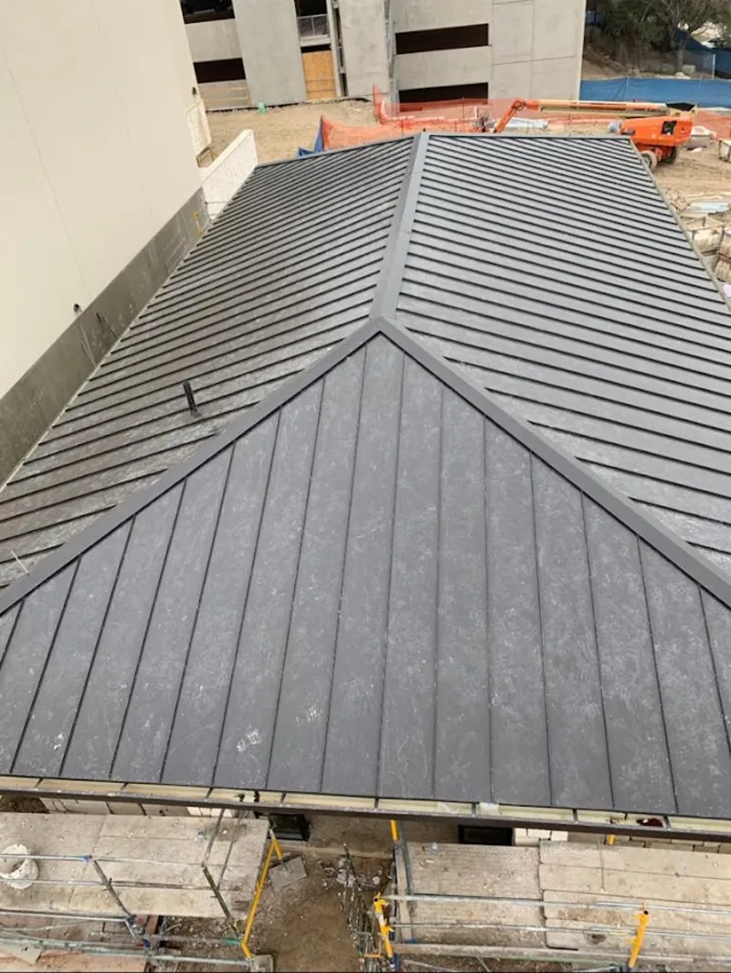 Commercial metal roof construction with crane equipment in White Oak