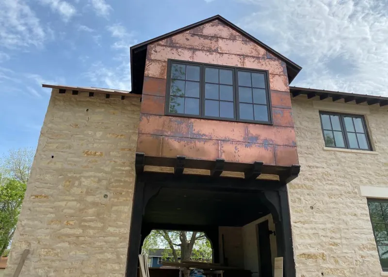 Copper metal panel facade on a stone building for Metal Roof Coating in White Oak