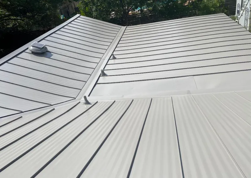 Solar attic fan installed on a metal roof for Roof Ventilation in White Oak